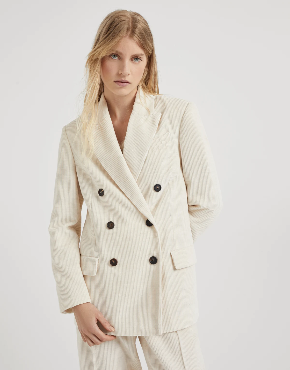 model wearing white blazer