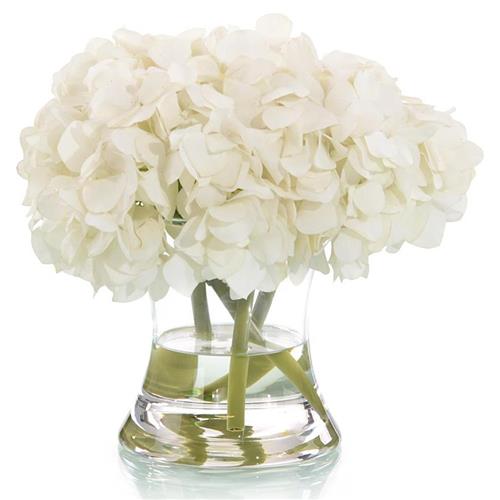 White faux hydrangea arrangement in glass vase