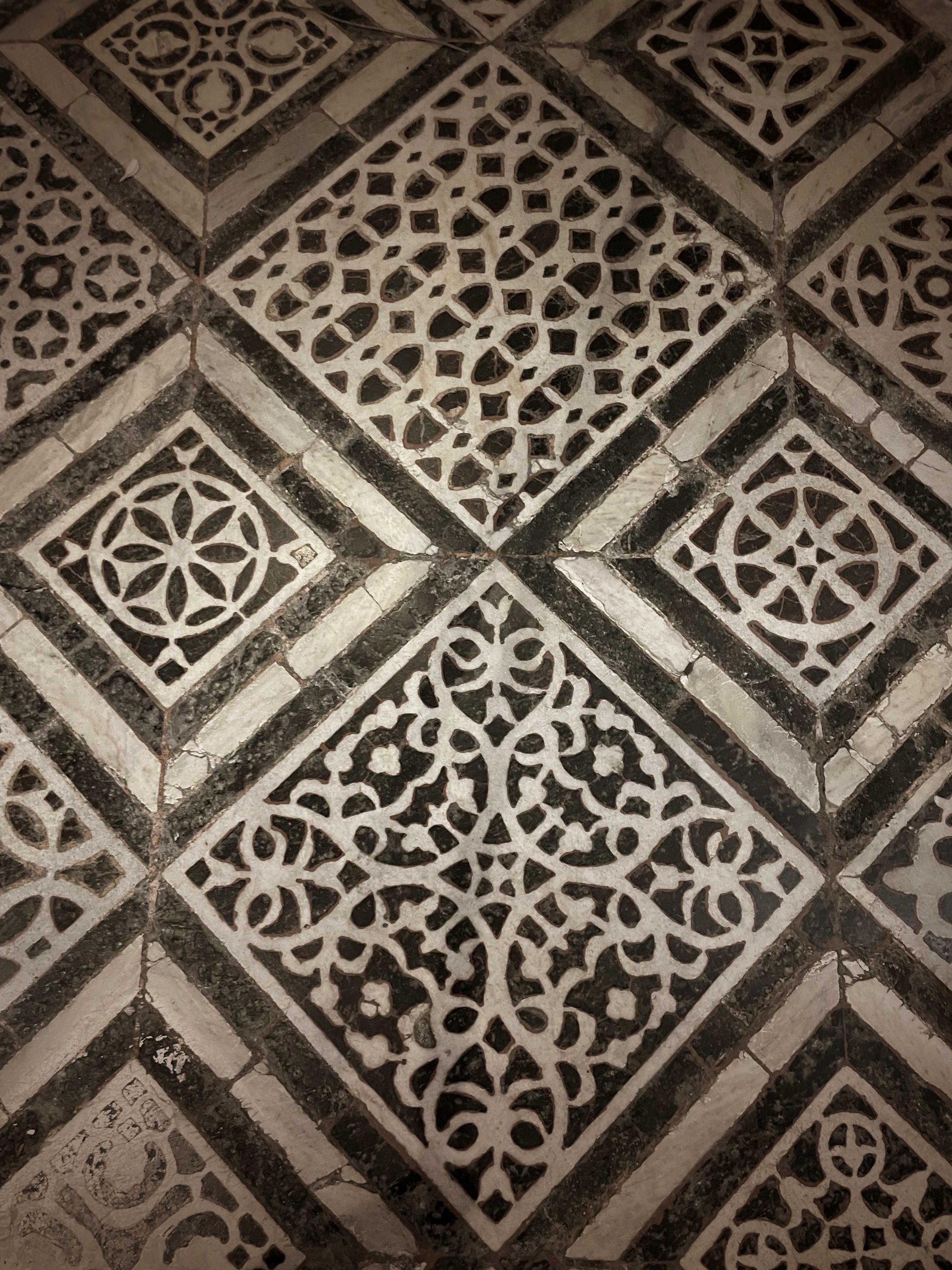 Patterned Italian stone floors in shades of black and cream