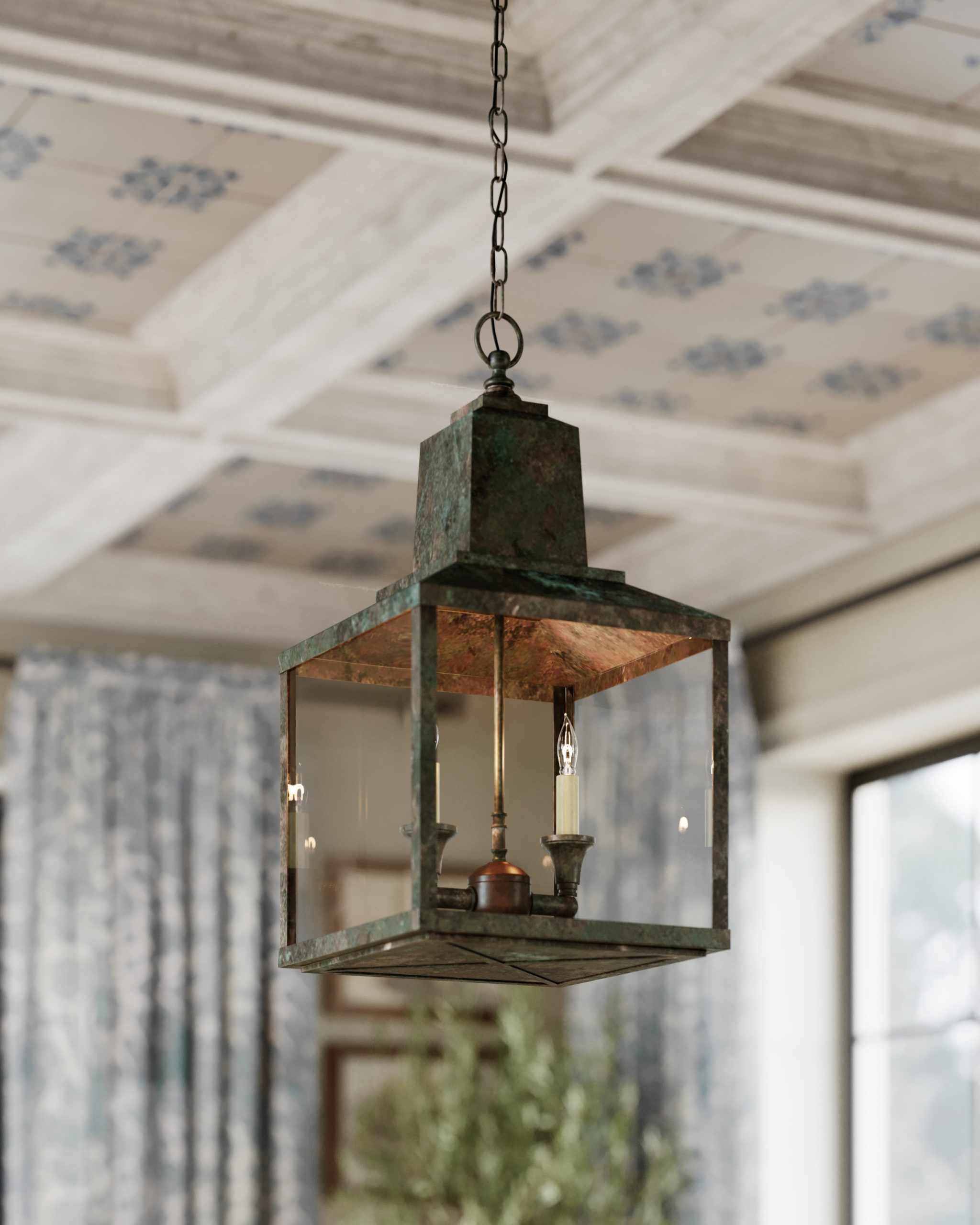 a metal lantern with a verdigris patina finish