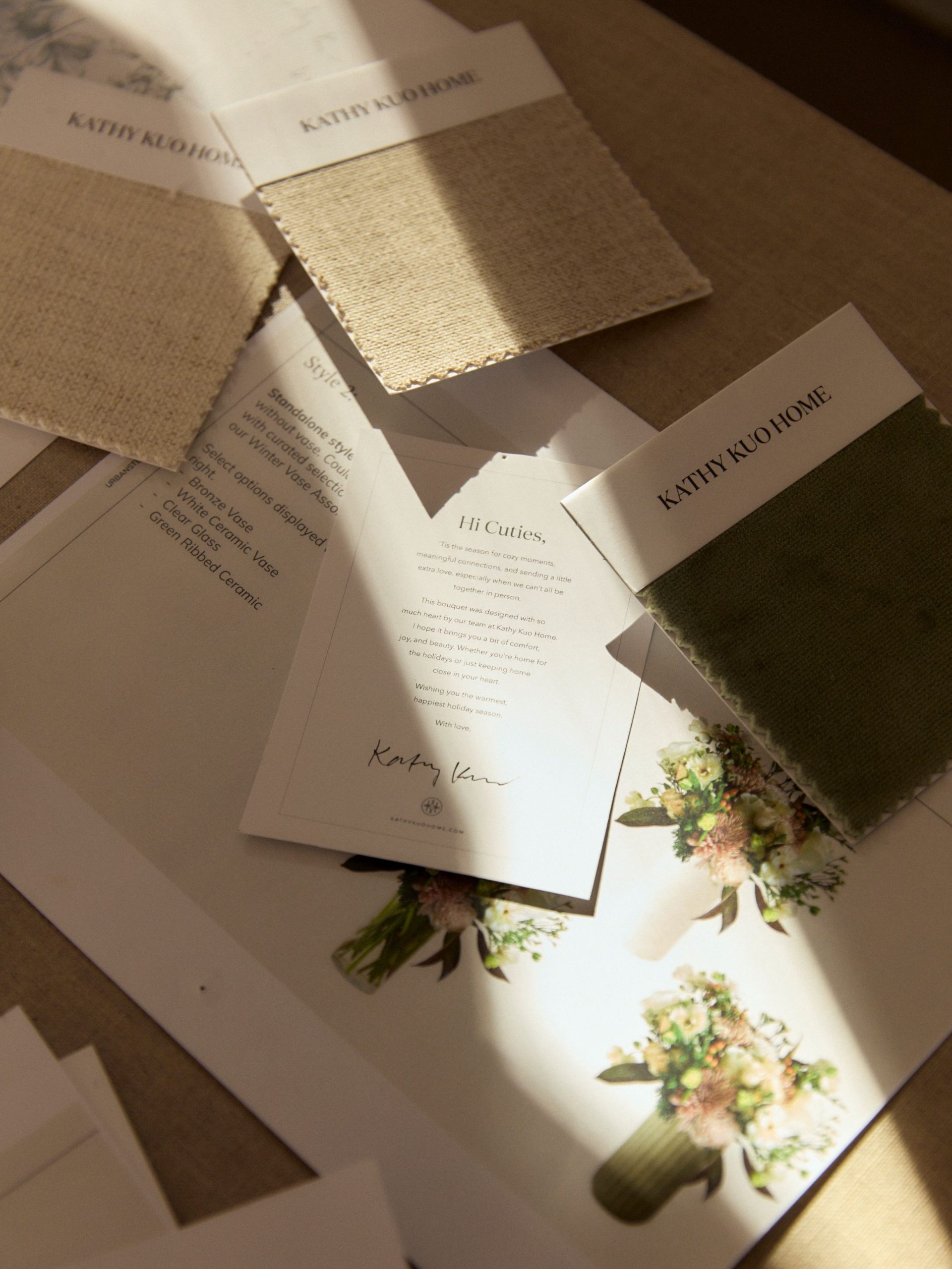 Kathy Kuo Home fabric swatches displayed on a table
