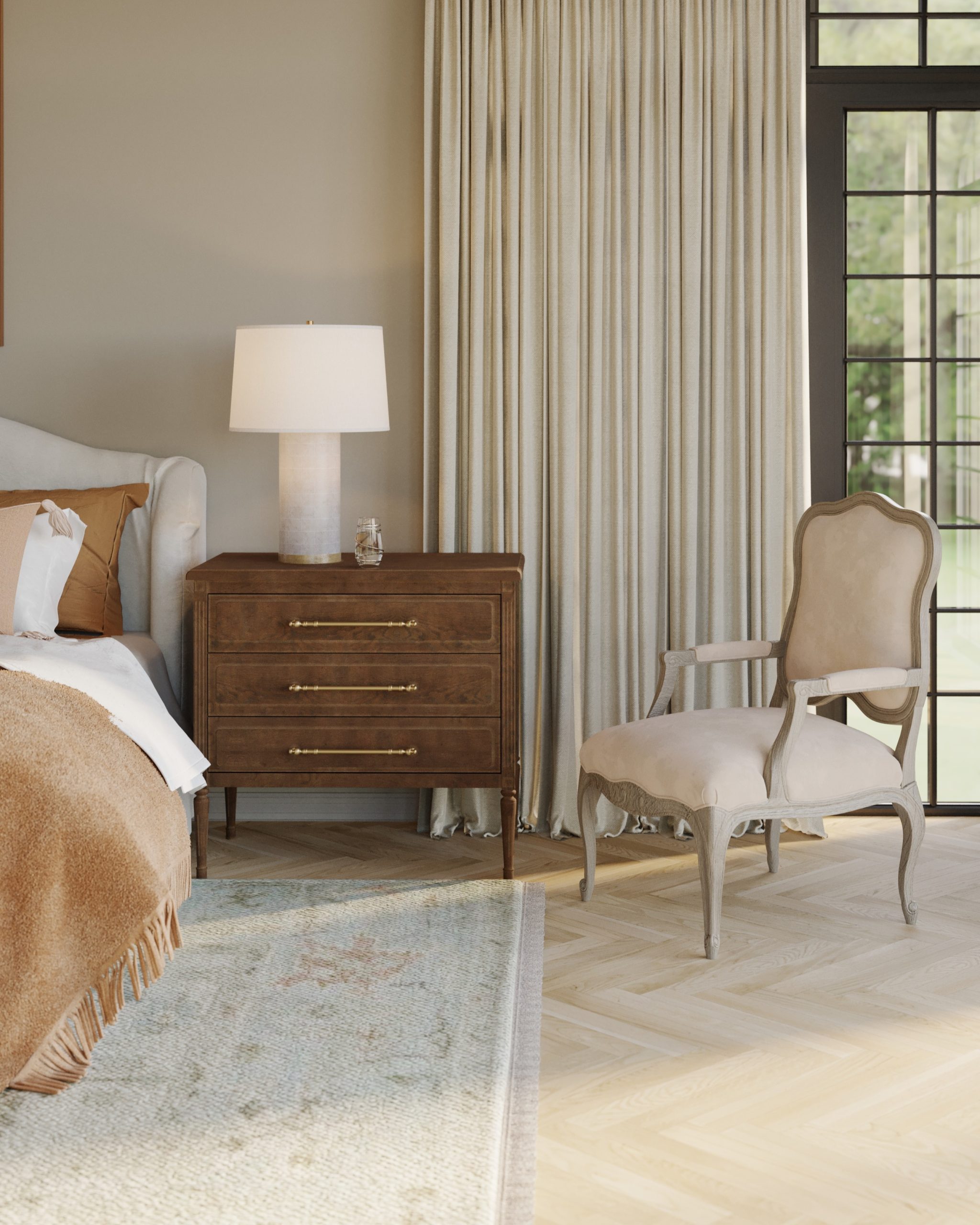 A french country bergere chair in a cozy primary bedroom